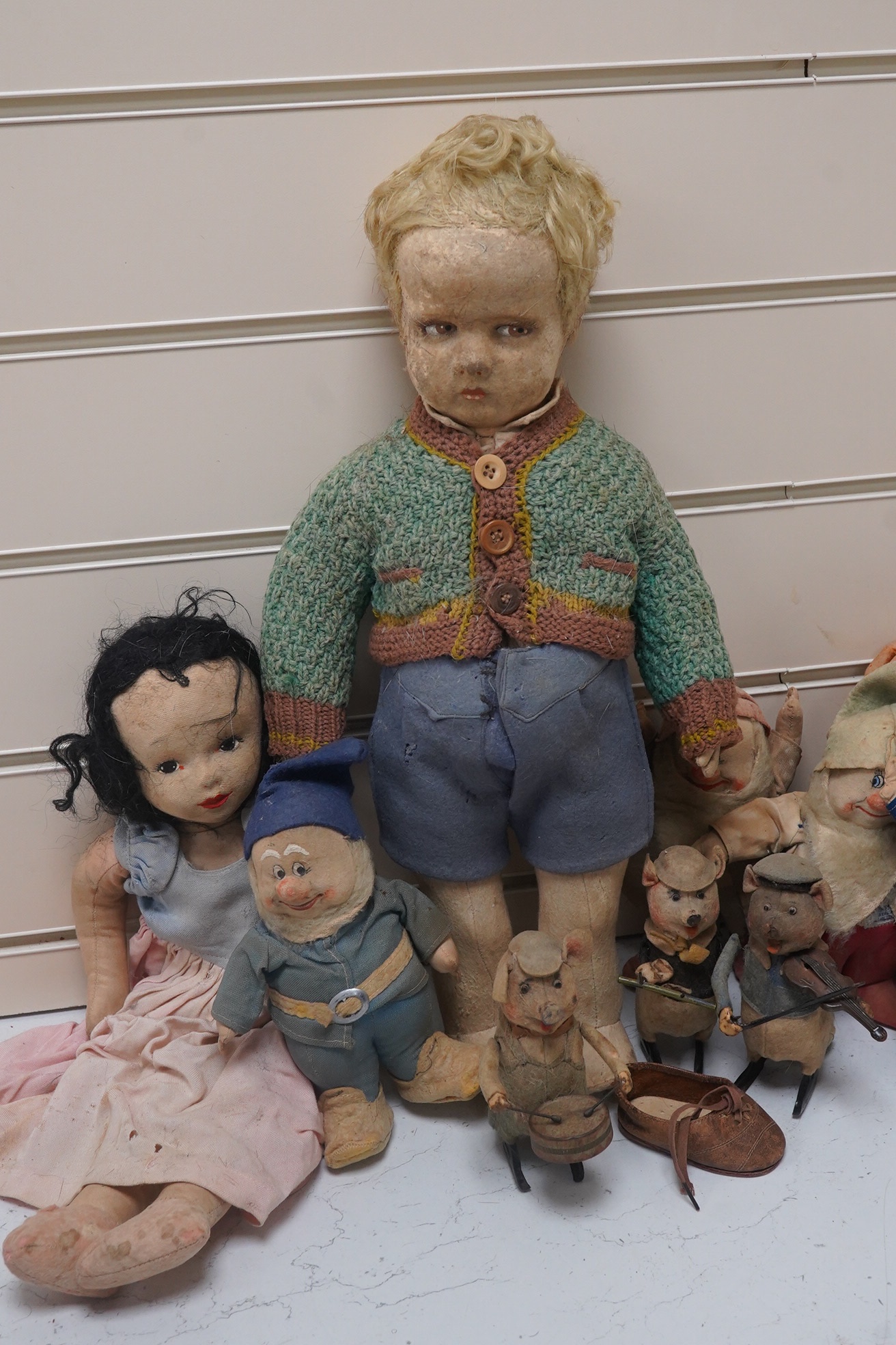 A Merrythought Hygienic Toys Snow White and the seven dwarves, three Schuco clockwork pig musicians and a felt doll. Condition - fair.